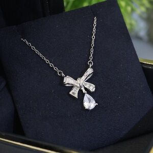 Elegant Silver Bow Necklace with Teardrop Pendant